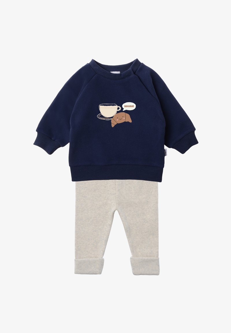 Navy blue sweatshirt with a cup and croissant graphic, paired with light gray ribbed pants featuring cuffed ankles.