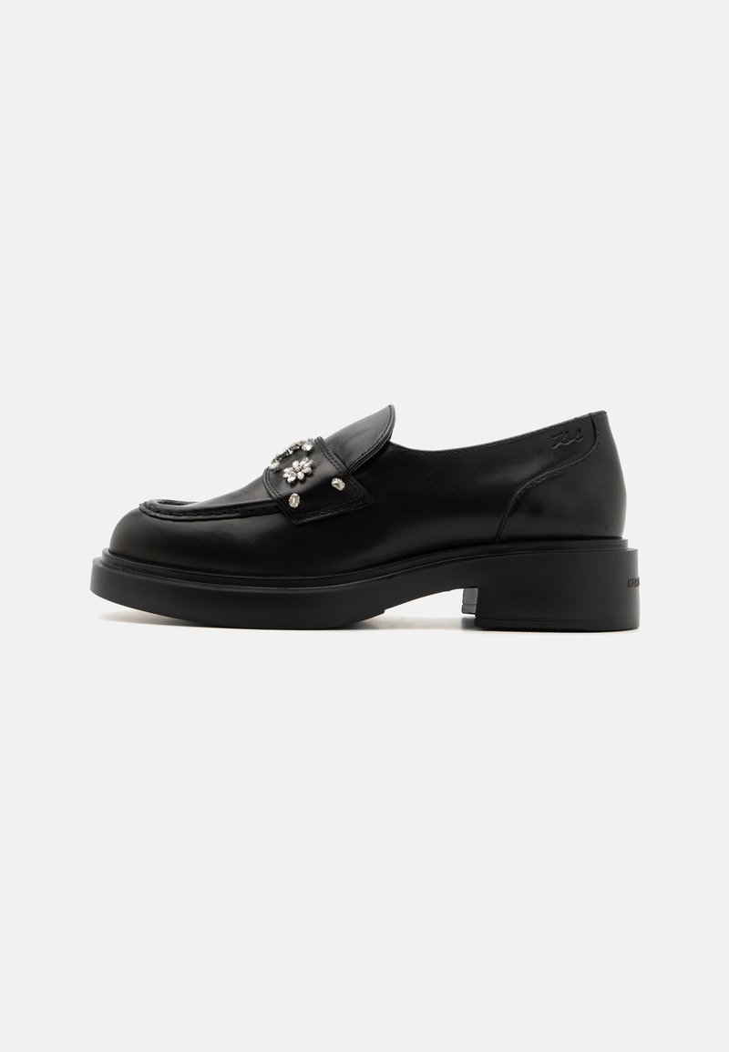 Schwarze Lederloafers mit runder Zehenform, dekorativen Blumenakzenten und einem niedrigen Blockabsatz. Glatte Textur, minimalistische Designelemente.