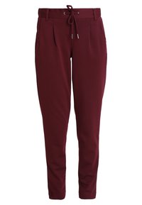 Burgundské jogger kalhoty vyrobené z měkké tkaniny, s páskem na šňůrku, předními sklady a manžetami u kotníků. Hladká textura a ležérní design.