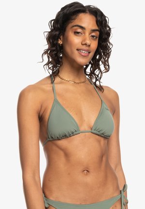 Green triangular bikini top with thin straps, gathered fabric, and a solid texture. Notable for its minimalistic design and color.