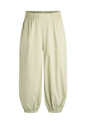 Pantalon beige coupe ample avec taille et poignets élastiques, doté de poches latérales et d'une coupe droite des jambes qui se rétrécit aux chevilles.
