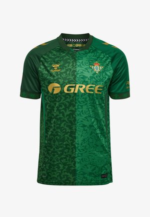 Maillot de football vert avec des motifs floraux verts foncés et clairs, logos dorés incluant "GREE," et un blason d'équipe vert et blanc couronné sur la poitrine.