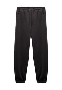 Sorte sweatpants lavet af blødt stof med elastisk talje og snøre, med sidelommer og manchetter ved anklerne.
