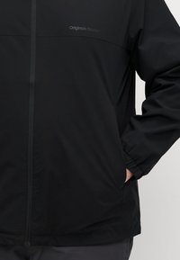 Black zip-up jacket with a smooth texture, featuring a logo on the chest and side pockets. The design has a relaxed fit and subtle detailing.
