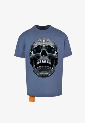 Blue t-shirt featuring a large black and silver skull graphic at the front, with a textured appearance and an orange tag at the hem.