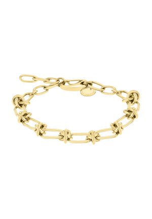 Bracelet en métal doré avec des maillons ovales et carrés entrelacés, rehaussé d'accents en forme de nœud, terminé par un fermoir sécurisé et une petite étiquette.