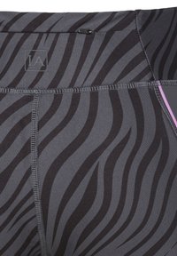 Grey athletic leggings with black and dark grey wavy stripes, featuring a wide waistband and a small logo at the top.