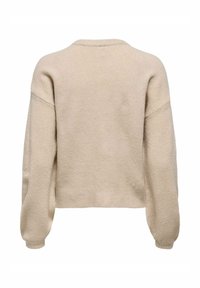 Beige Wollpullover mit einem verkürzten Design, überschnittenen Schultern und geripptem Saum. Weiche Textur und einfache Konstruktion ohne sichtbare Muster.