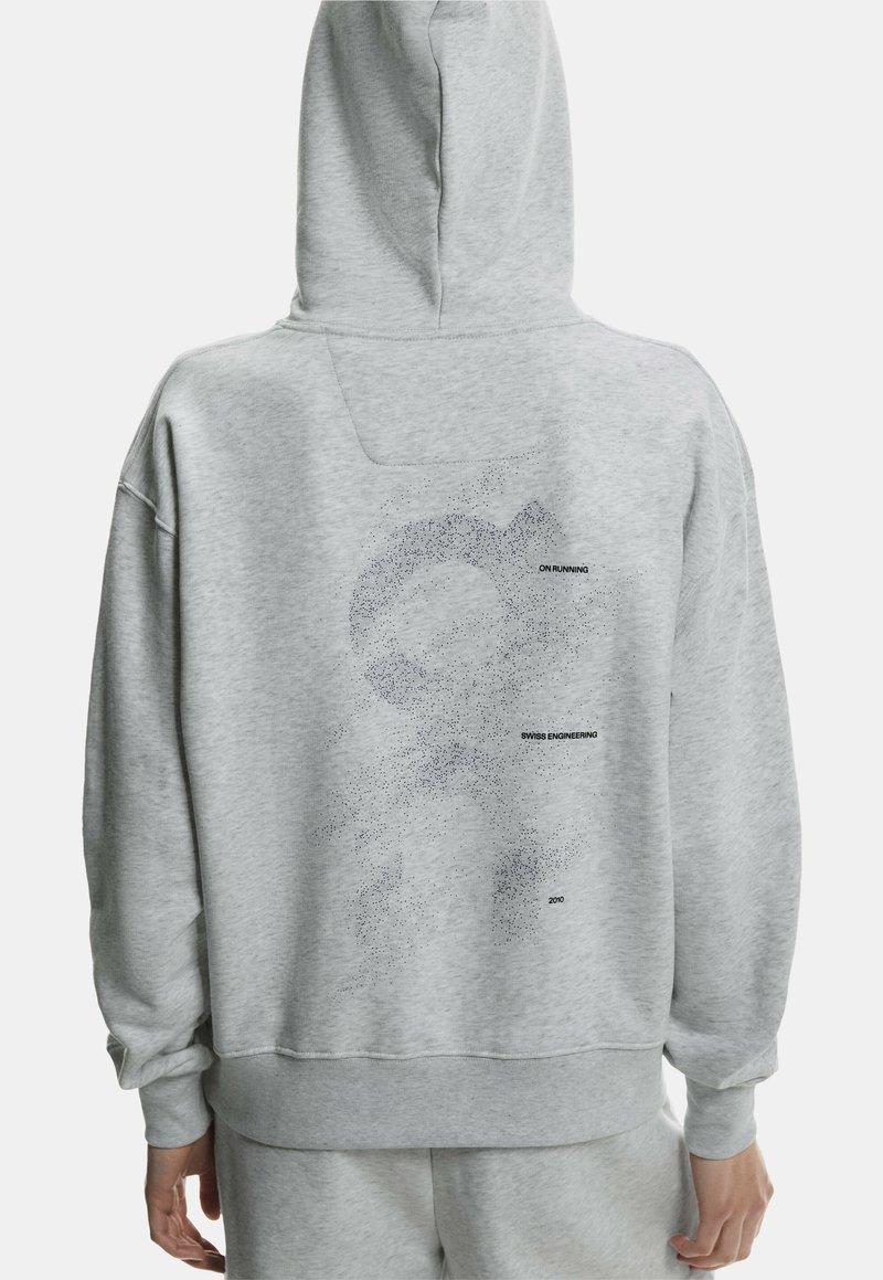 Gray hooded sweatshirt with a relaxed fit, featuring a dotted graphic and text "ON RUNNING," "SWISS ENGINEERING," and "2010" on the back.