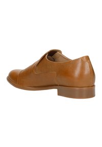 Bruine leren schoen met een gladde textuur, met een ronde neus, enkelhoogte en een lage, stevige hak. Minimale stikseldetails.