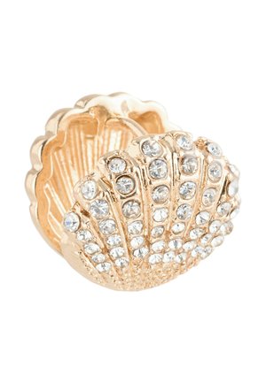 Gold-tone shell-shaped ring adorned with clear rhinestones, featuring ribbed detailing and a polished texture.