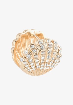 Gold-tone shell-shaped ring adorned with clear rhinestones, featuring ribbed detailing and a polished texture.