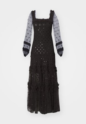 Black maxi dress with long sheer sleeves, square neckline, ruffled accents, textured polka dot pattern, and layered frill detailing.