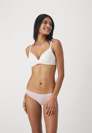 Soutien-gorge moulé blanc avec de fines bretelles et un décolleté en V, associé à un slip de bikini rose clair avec une taille élastique douce.