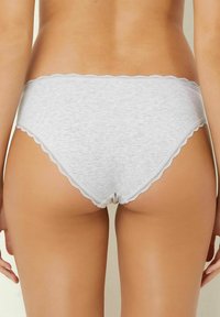Gray cotton panty with scalloped lace trim, featuring a low-rise design and smooth texture, displayed from the back.