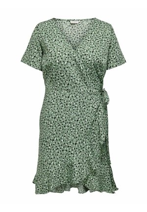 Groene wikkeljurk met korte mouwen, kleine zwart-witte abstracte stippen, strik aan de zijkant en geplooide zoom.