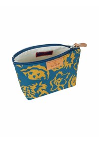 Zippered pouch in blue fabric with yellow floral pattern, leather accent on top, and cream-colored interior lining. Compact rectangular shape.