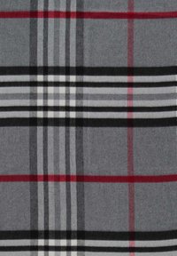 Tissu gris avec un motif à carreaux présentant des lignes croisées noires, blanches et rouges formant un design tartan classique.