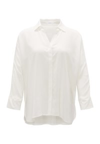 Blouse blanche à manches longues de coupe ample avec col, encolure en V, patte de boutonnage cachée et ourlet légèrement arrondi.