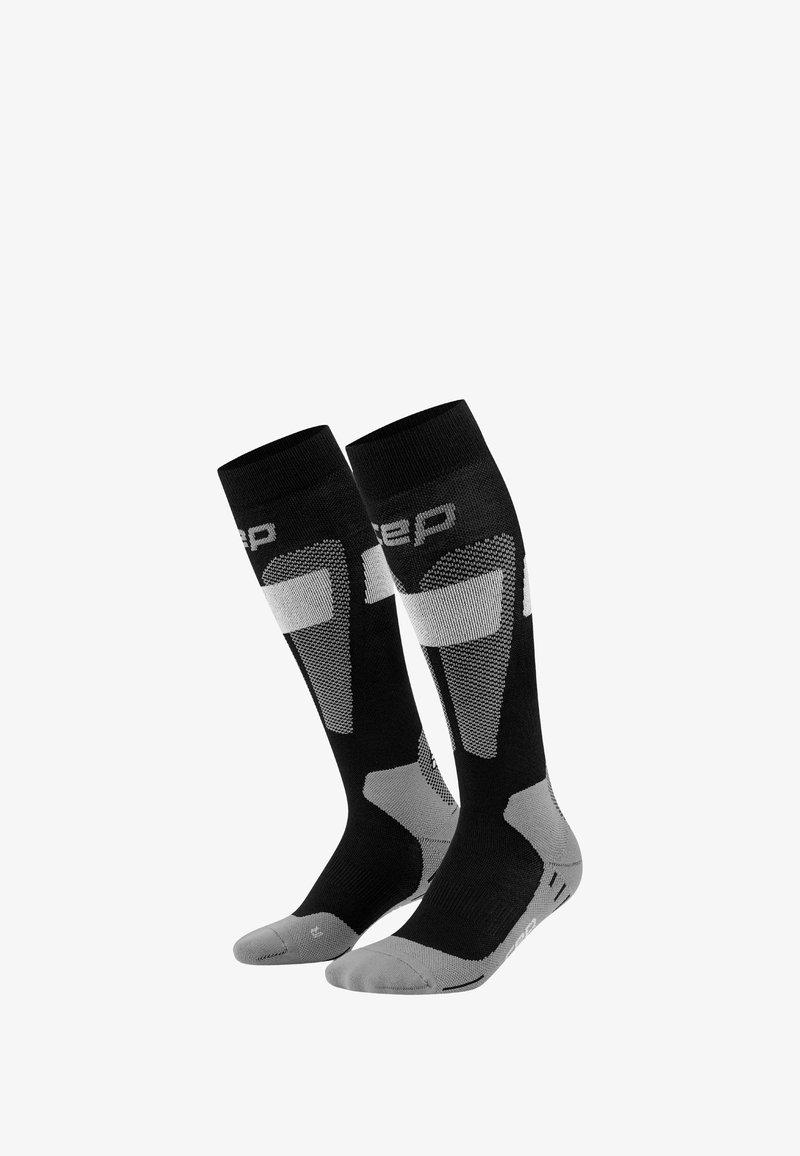 Paar schwarze und graue kniehohe Sportsocken mit gepolsterten Sohlen und gemusterten Belüftungszonen.