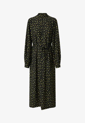 Robe noire à manches longues, col montant et ceinture à nouer. Présente un motif floral jaune sur fond noir. Longueur mi-mollet.