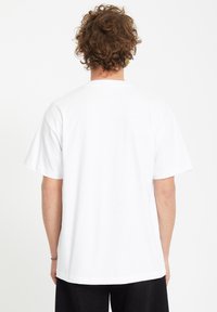 Weißes kurzärmliges T-Shirt mit lockerem Schnitt, das ein einfaches Design und eine glatte Textur aufweist. Keine sichtbaren Logos oder Muster.