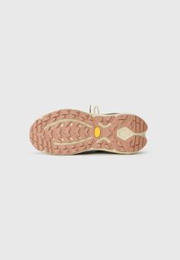 Jasnobeżowa i brązowa podeszwa sportowa z wyraźnym wzorem bieżnika, z logo Vibram w kolorze żółtym oraz teksturowanymi obszarami dla lepszej przyczepności i chwytu.
