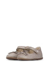 Zapatos de niña pequeños de color rosa brillante con punta redondeada, una única tira de velcro y un lazo en la parte frontal. Forro interior suave y suela flexible.