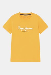 Żółta bawełniana koszulka z krótkim rękawem, z białym logo "Pepe Jeans" i napisem "LONDON" pod spodem w kolorze szarym. Gładka tekstura.
