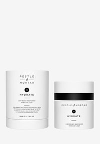 Hydratant léger dans un pot blanc et un contenant cylindrique. Les deux présentent du texte et des accents noirs, avec un design épuré et minimaliste.