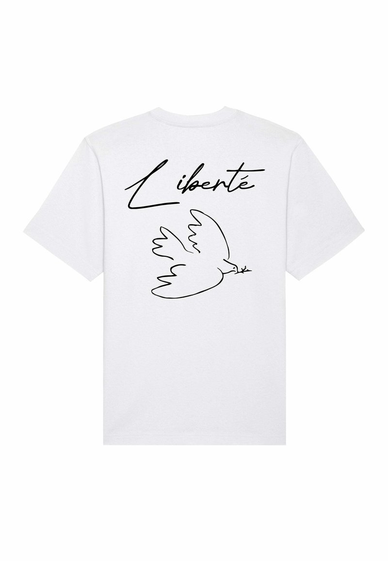 Witte katoenen T-shirt met een zwarte omtrek van een duif en het woord "Liberté" in een vloeiende schrift op de rug. Korte mouwen, ronde hals.