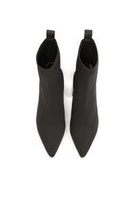 Black knitted ankle boots with a pointed toe and ribbed upper, featuring a pull tab at the back for ease of wear.