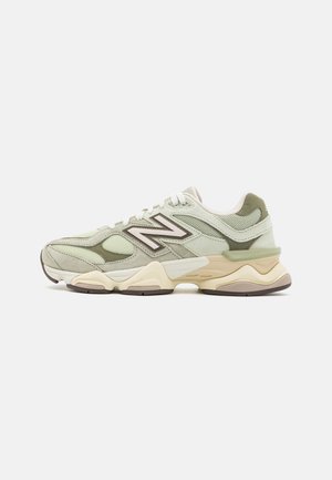 Low-top New Balance sneakers i beige og lysegrøn med mesh og ruskindspaneler, chunky sål og logo på siden.