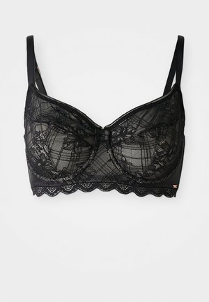 Bralette en dentelle noire avec armatures, présentant des motifs floraux, des bords festonnés, des bretelles ajustables et un détail de nœud au centre.