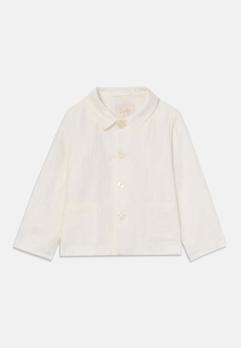 Balta lina jakas ar noapaļotu apkakli, ar priekšējo pogu aizdari un divām kabatām. Iezīmējas ar mīkstu tekstūru un vieglu dizainu.