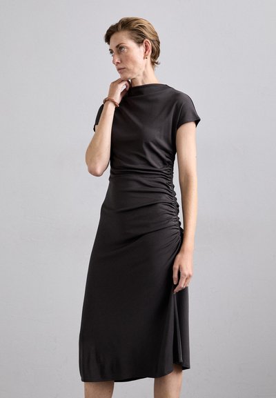 Dark gray dress with short sleeves, ruched detail on the side, smooth fabric, knee-length with a slight front slit at the hem.