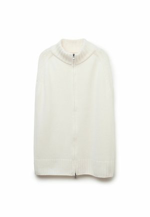 Strickcape in Creme mit hohem Kragen, geripptem Saum und einem Frontreißverschluss. Verfügt über ein Zopfmuster an den Schultern. Weiche Textur.