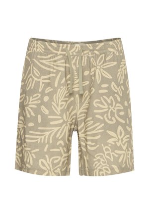 Valged beežid lühikesed püksid, millel on suur, abstraktne oliivroheline lehemuster, elastne vöökoht paelaga ja lõdvestunud lõige.