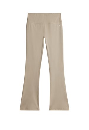Beige flared yoga broek gemaakt van rekbaar materiaal, met een hoge tailleband en een gladde textuur. Logo gedrukt op de tailleband.