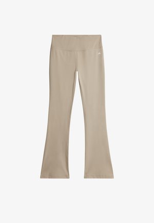 Beżowe szerokie legginsy do jogi wykonane z elastycznego materiału, z wysokim stanem i gładką fakturą. Logo nadrukowane na pasie.