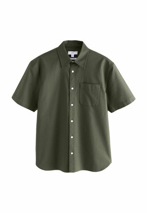 Chemise à manches courtes en coton vert foncé, avec un col boutonné, une poche à l'avant et des boutons blancs le long de la patte de boutonnage.