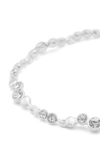 Bracelet en argent comprenant des perles rondes et lisses, avec des pierres précieuses transparentes alternées, affichant une finition polie et un design délicat.