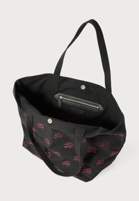 Black tote bag with red patterned logo design, two shoulder straps, magnetic snap closure, and interior zippered pocket.