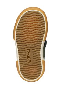 Suola in gomma con un motivo testurizzato ondulato, di colore beige, con il logo "GEOX". Il bordo è bianco, creando un contrasto con la suola.