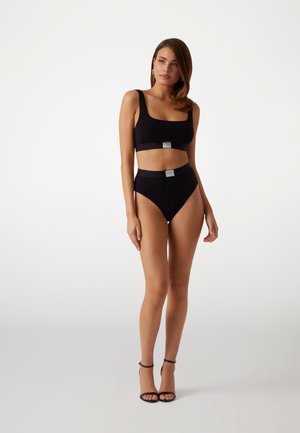 Black two-piece swimwear set featuring a square-neck top and high-waisted bottoms, made of smooth, stretchy fabric with branded accents.