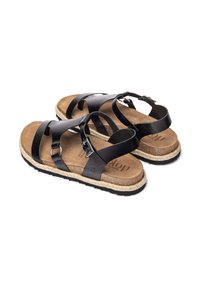Sandali neri in pelle con più cinturini, soletta in sughero, intersuola in juta intrecciata e suola in gomma; dettaglio della fibbia regolabile visibile.
