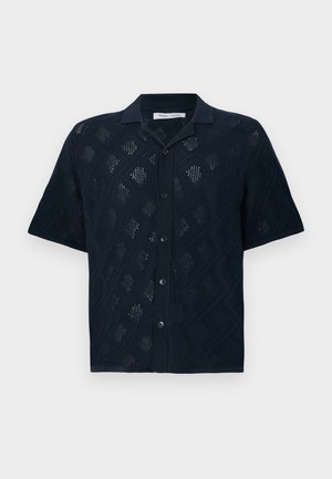 Navy short-sleeve shirt featuring a diamond pattern with open knit texture, five buttons down the front, and a collared design.