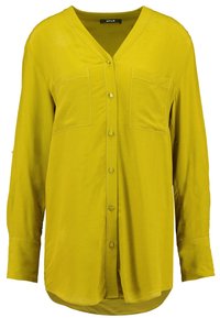 Gul, långärmad skjorta med V-ringning, knäppning fram, två bröstfickor och rundad nederkant. Mjukt tyg med en slät textur.