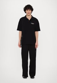 Les Benjamins Polo - black