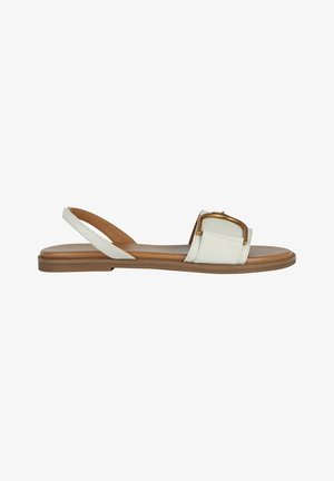 White leather sandal with a wide strap and a gold-tone buckle detail. Features a flat brown sole and an open back design.